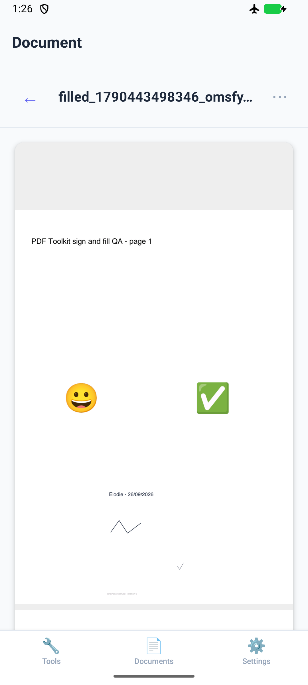 Saved PDF reopened in the app, showing a smile, check symbol and an added image with fictional text and signature